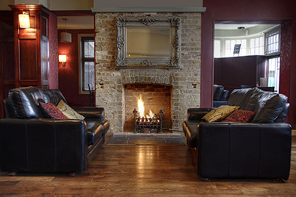 Image: A family room with a fireplace discussing chimney & fireplace retrofits