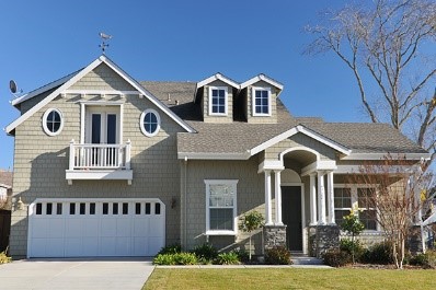 Gray, two-story house with living space over the garage