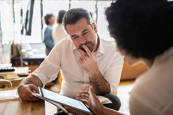 Image: Two people reviewing a document